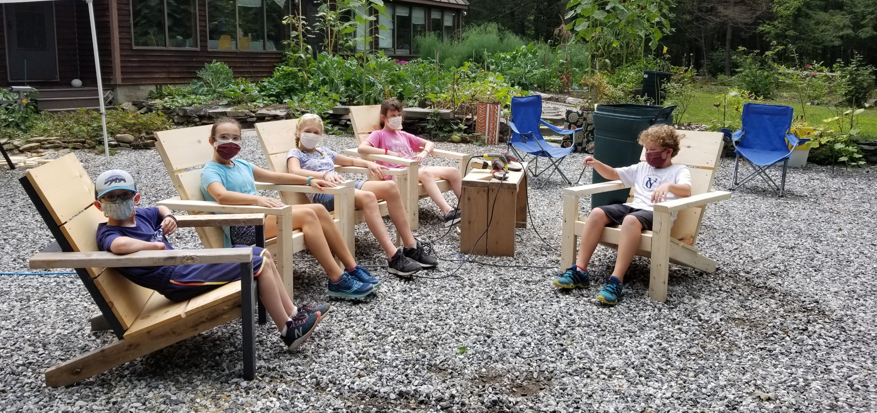 Kids relaxing in the adirondack chairs they built themselves