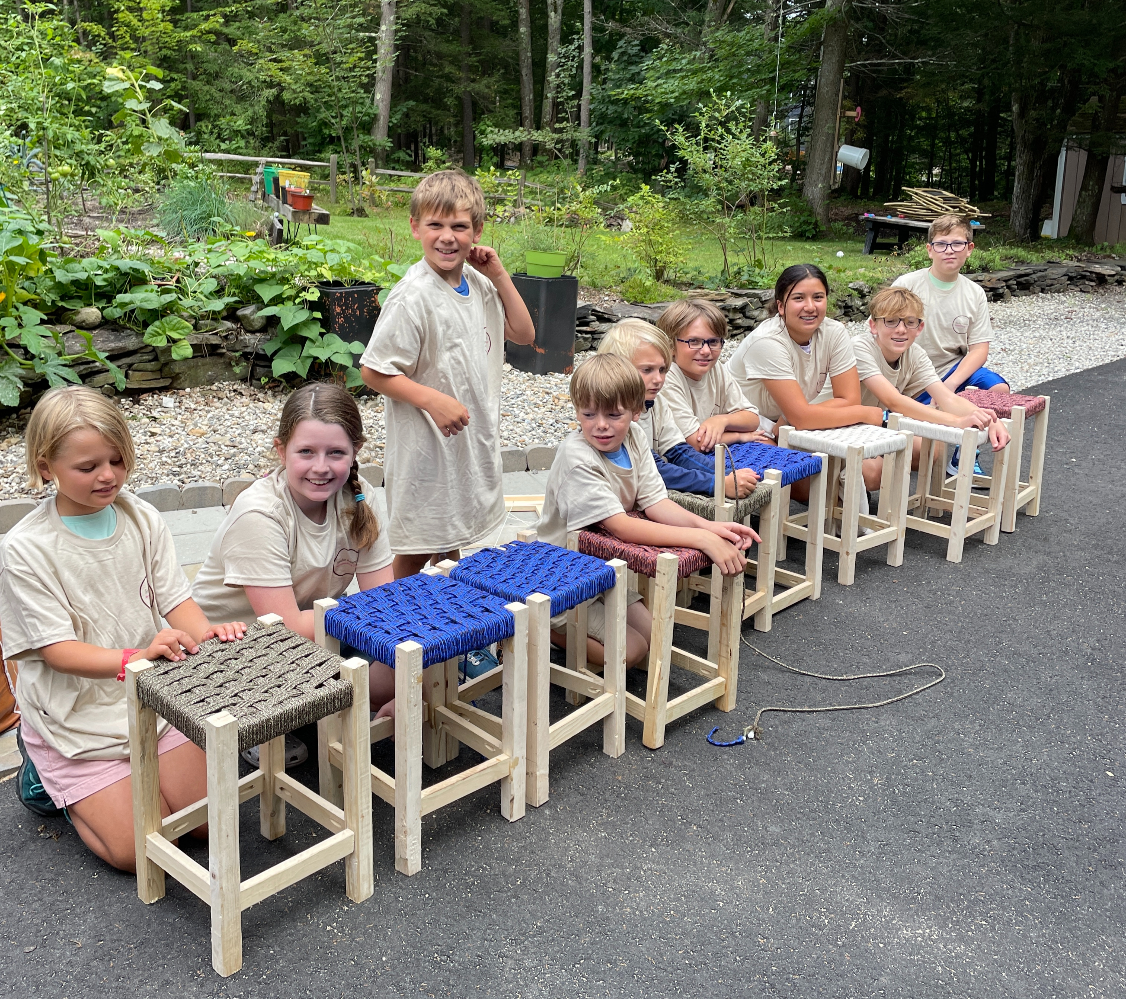 Summer camp students with their finished hand-woven stools