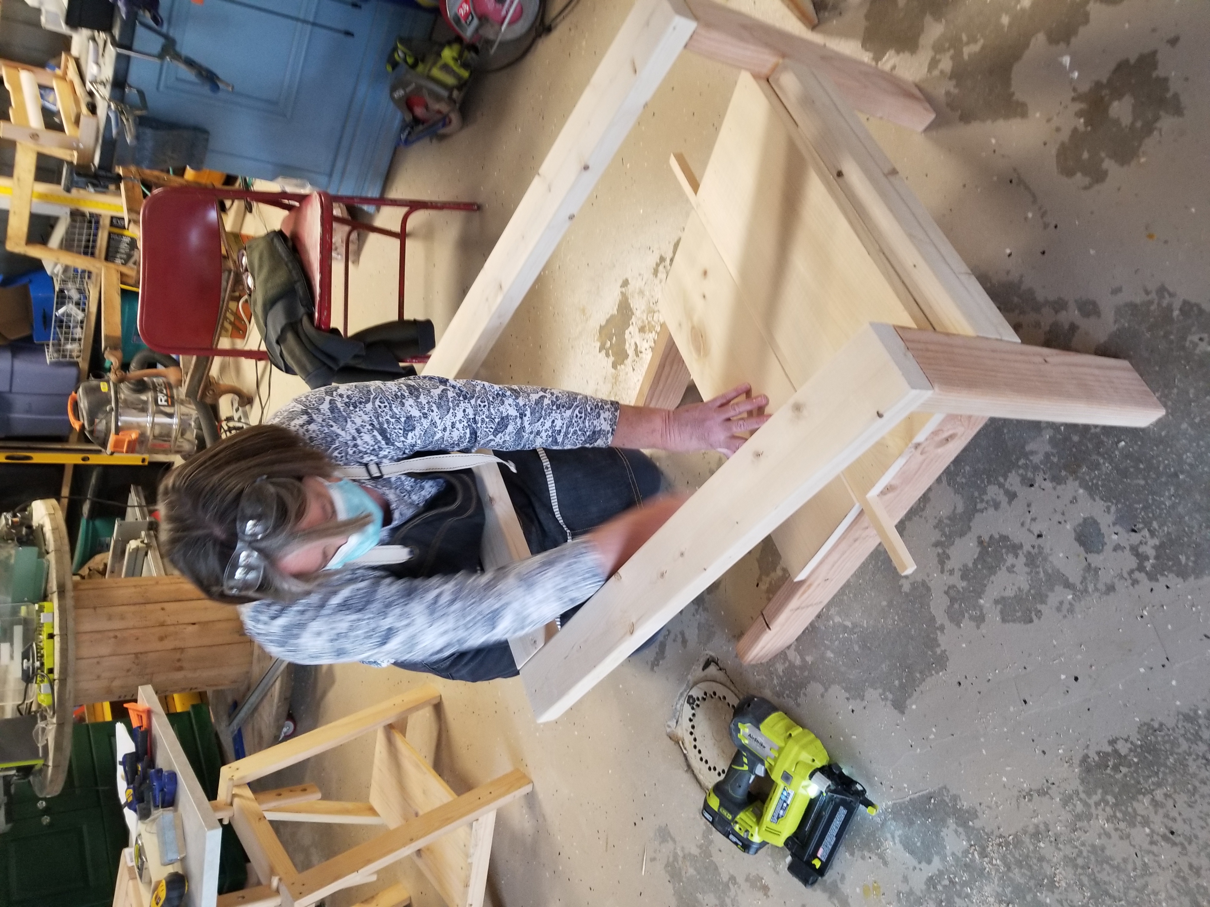 Sandrine working at the studio bench in safety gear