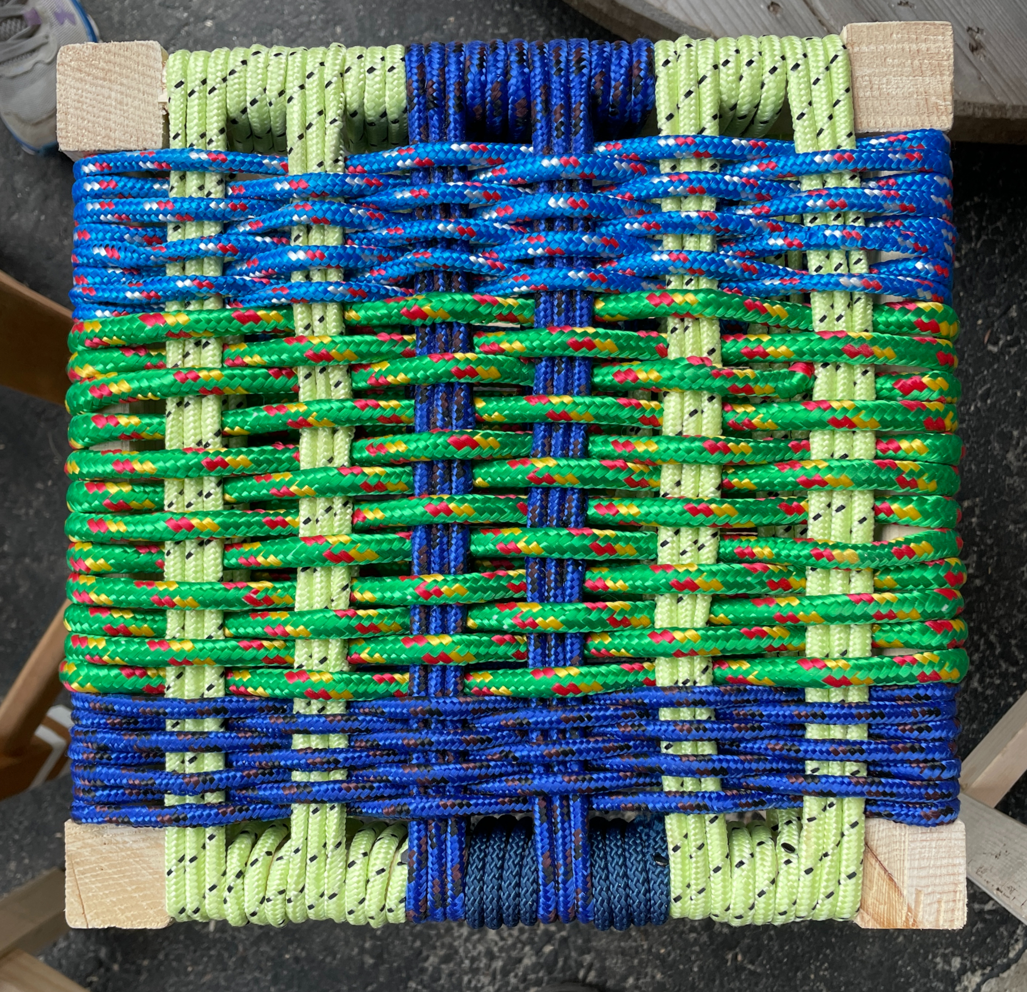 Close-up of a hand-woven cord seat from the All Day Stool class